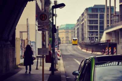 Rear view of women walking on street in berlin city