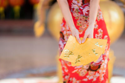 Close-up of woman holding umbrella