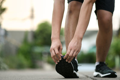 Low section of woman running