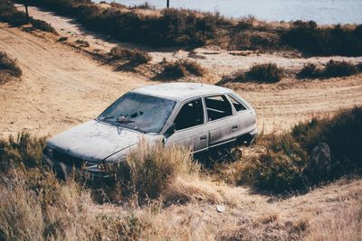 High angle view of abandoned car on field