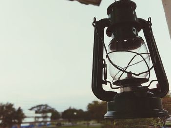 Low angle view of lantern hanging against sky