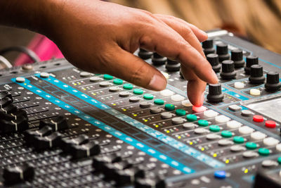 Cropped image of hand adjusting sound mixer