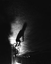 Shadow of person riding bicycle on street