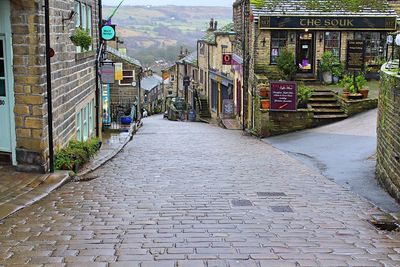 Empty alley amidst buildings in city