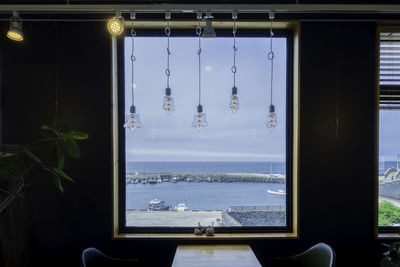 Panoramic view of sea against sky seen through window