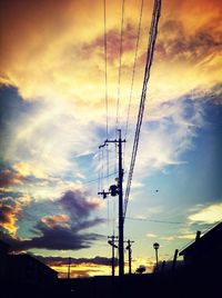 Low angle view of electricity pylon against sky