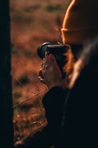 Portrait of woman holding camera