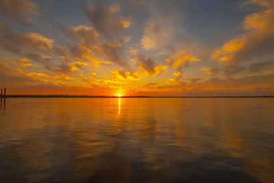 Scenic view of sea against romantic sky at sunset