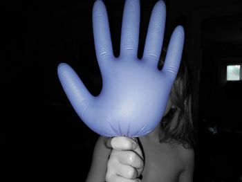 Close-up of human hand against blue background