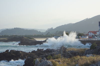 Scenic view of waterfall against sky