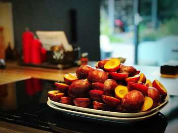 Close-up of fruits in plate on table at home