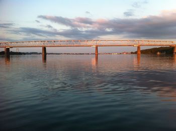 Pier over sea against sky during sunset