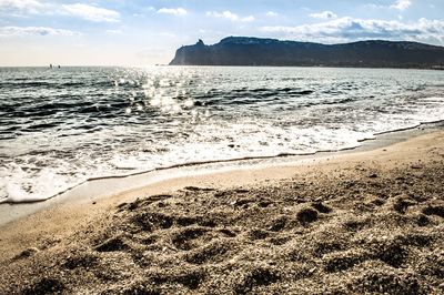 Scenic view of beach against dramatic sky