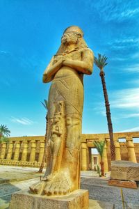 Low angle view of statue against blue sky