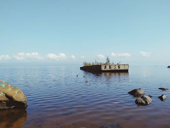 View of groyne in sea against sky