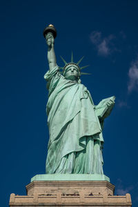 Low angle view of statue of liberty against sky