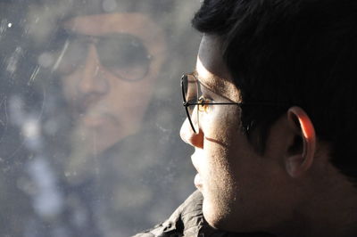 Close-up portrait of young man looking away