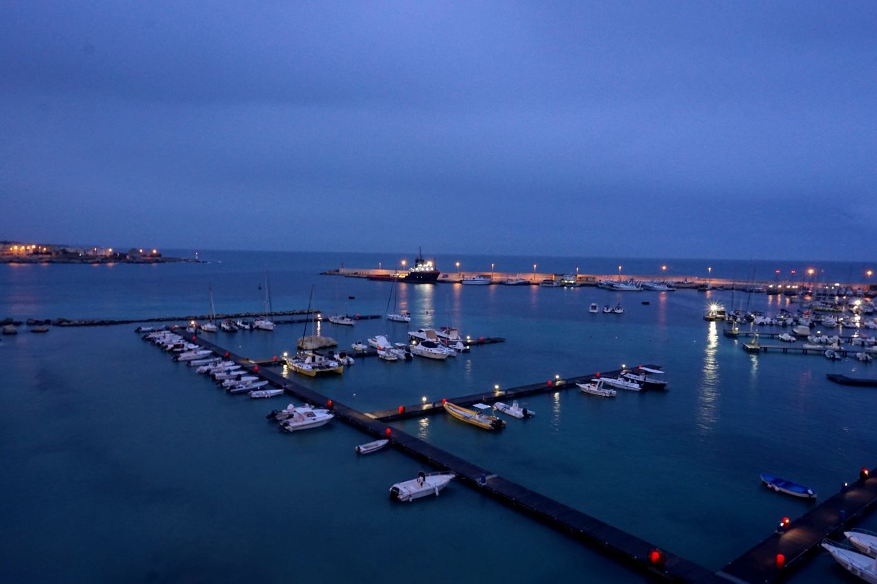 nautical vessel, sea, water, transportation, illuminated, moored, sky, no people, outdoors, mode of transport, harbor, architecture, city, nature, scenics, night, commercial dock, building exterior, beauty in nature, cityscape, horizon over water, yacht