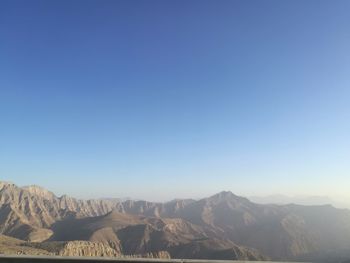 Scenic view of mountains against clear blue sky