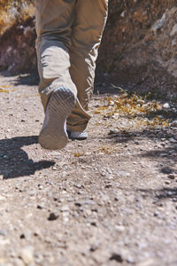 Young tourist walks on a path to the mountain. adventure travel, hiking concept.