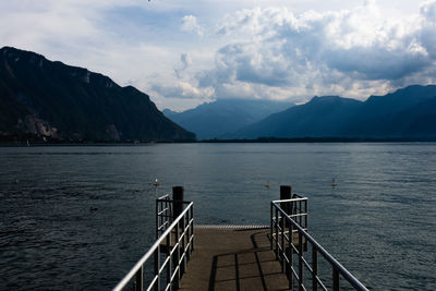 Pier over lake against sky