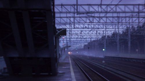 Railroad tracks in city against sky