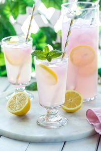 Refreshing lemonade with pink lemonade ice cubes, ready for drinking.