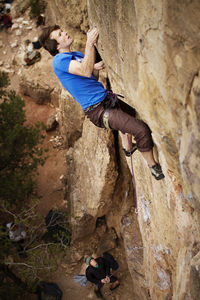 Side view of man climbing mountain