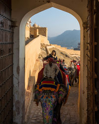 Rear view of people on historical building