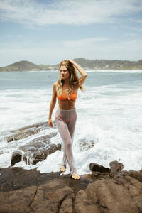 Young woman standing on beach