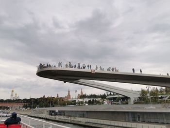 Bridge over road against sky in city