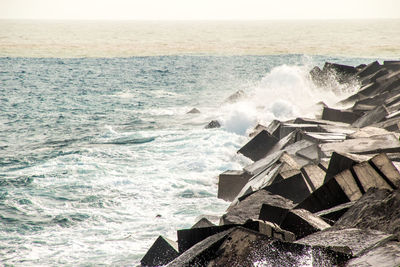 Scenic view of sea waves splashing on rocks