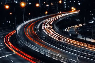 High angle view of light trails on highway at night