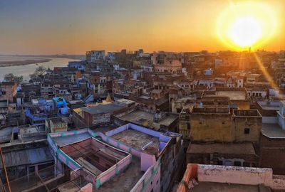 Aerial view of cityscape against sky during sunset