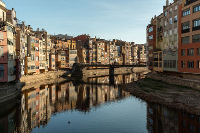 Reflections in the water to the colorful buildings and historic charm, girona in catalunya, spain