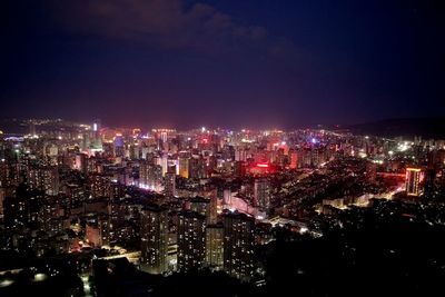 High angle view of illuminated city buildings at night