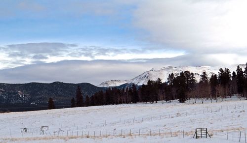 Scenic view of landscape against sky during winter