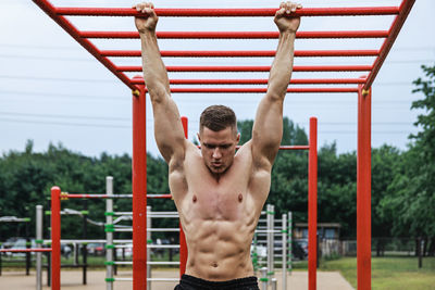 Portrait of young woman exercising in gym