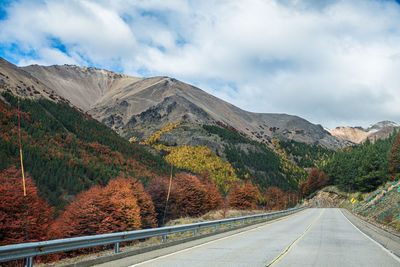 Road amidst mountains against sky