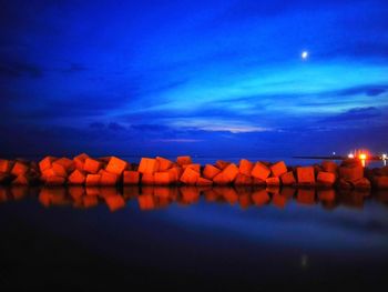 Scenic view of sea against blue sky at dusk