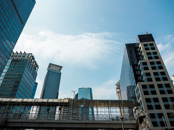 Low angle view of modern buildings against sky in city