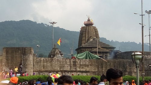 Woman in front of building with mountains in background