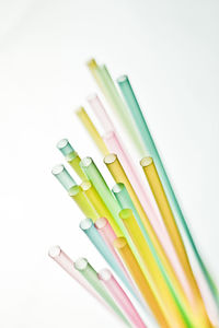 Close-up of colored pencils over white background