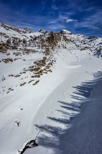 Scenic view of snow covered mountains against sky