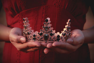 Close-up of woman holding crown