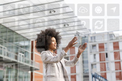 Young woman standing by glass window