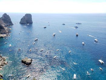 High angle view of rocks in sea against sky