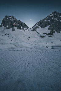 Scenic view of snowcapped mountains against clear sky