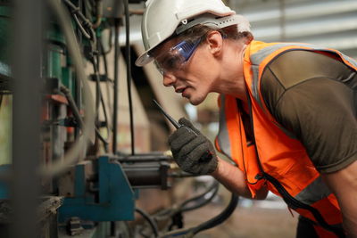 Young man working in factory