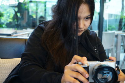 Portrait of young woman photographing